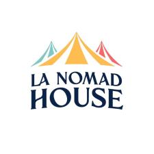 Logo with 'La Nomad House' written in black against a white background, with three circus tents - blue, yellow and pink - behind.